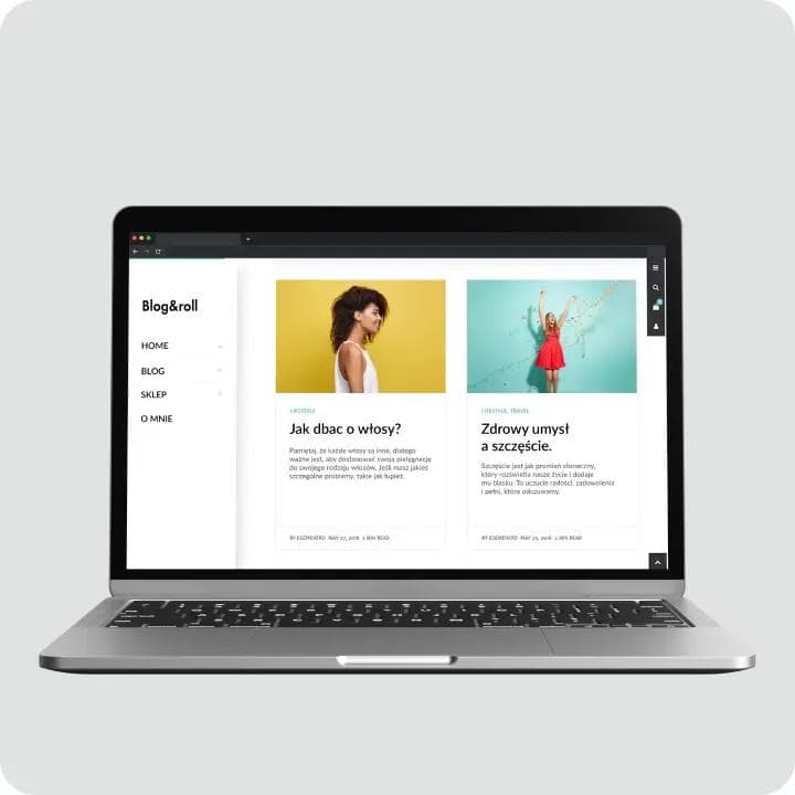 Srebrno-czarny laptop, na ekranie pokazana jest przykładowa strona internetowa.