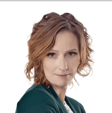 Kobieta z krótkimi blond włosami w zielonej marynarce – właścicielka marki Słowa Klucze.